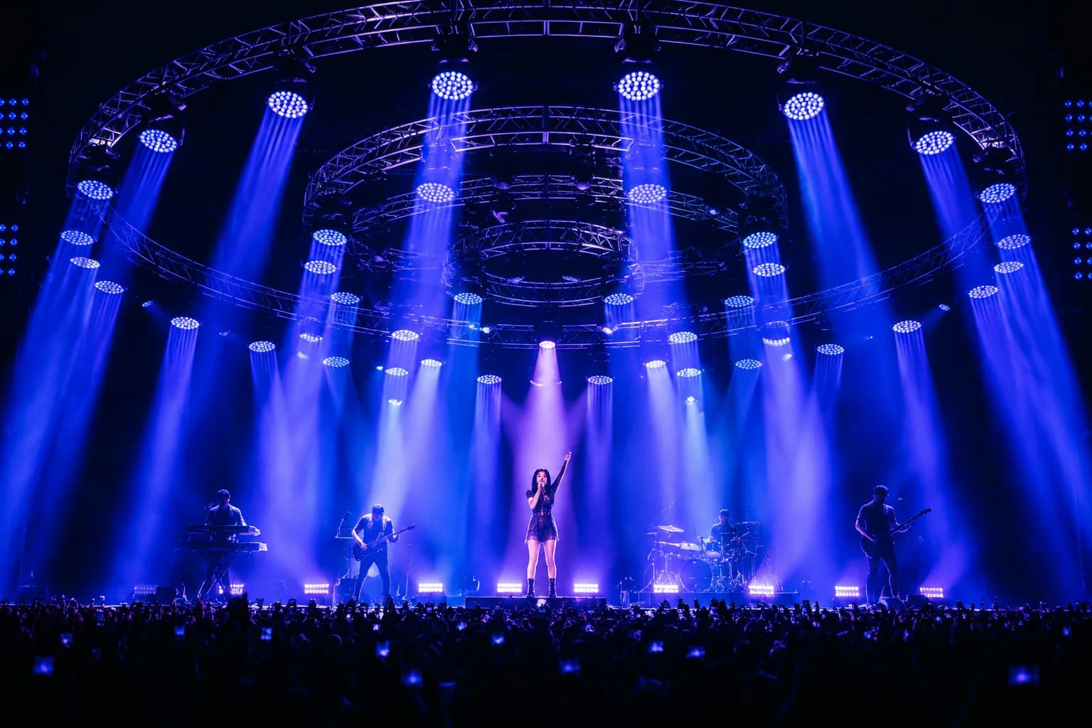 Concert performance with circular truss and blue moving head beams