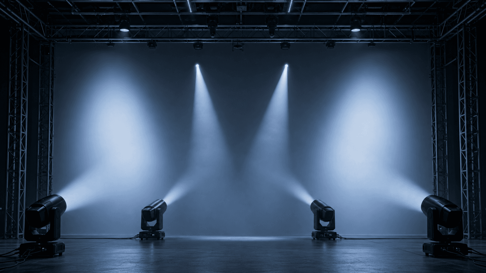 Four generic zoom wash moving heads demonstrating narrow and wide blue-white coverage on a test stage