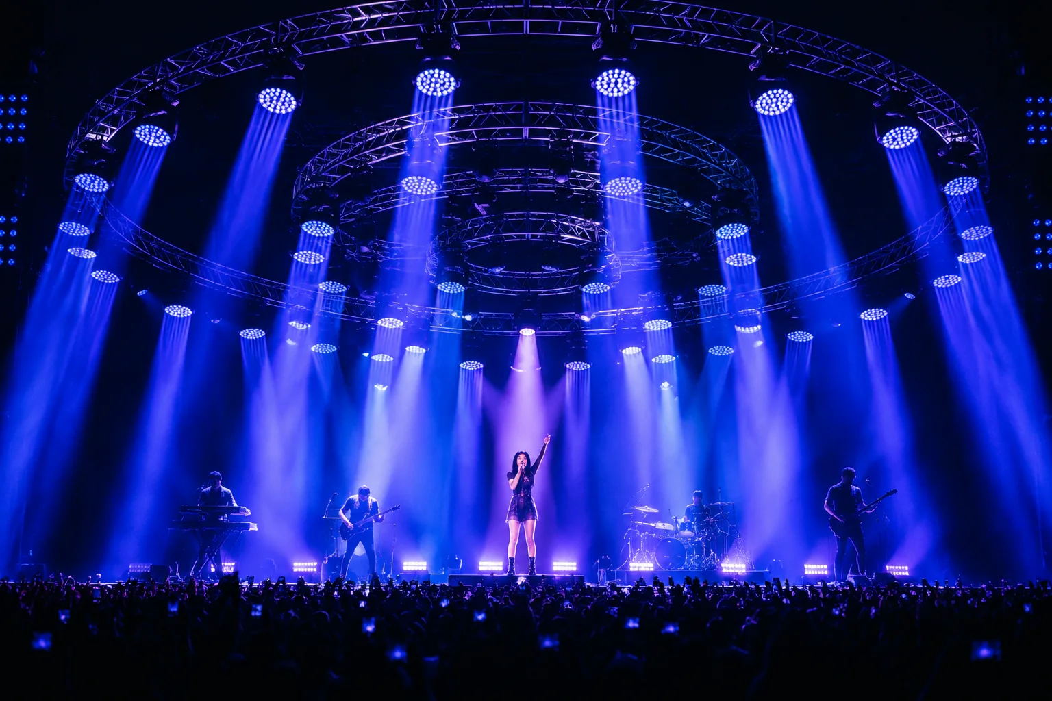 Blue concert-stage wash lighting across a live performance area