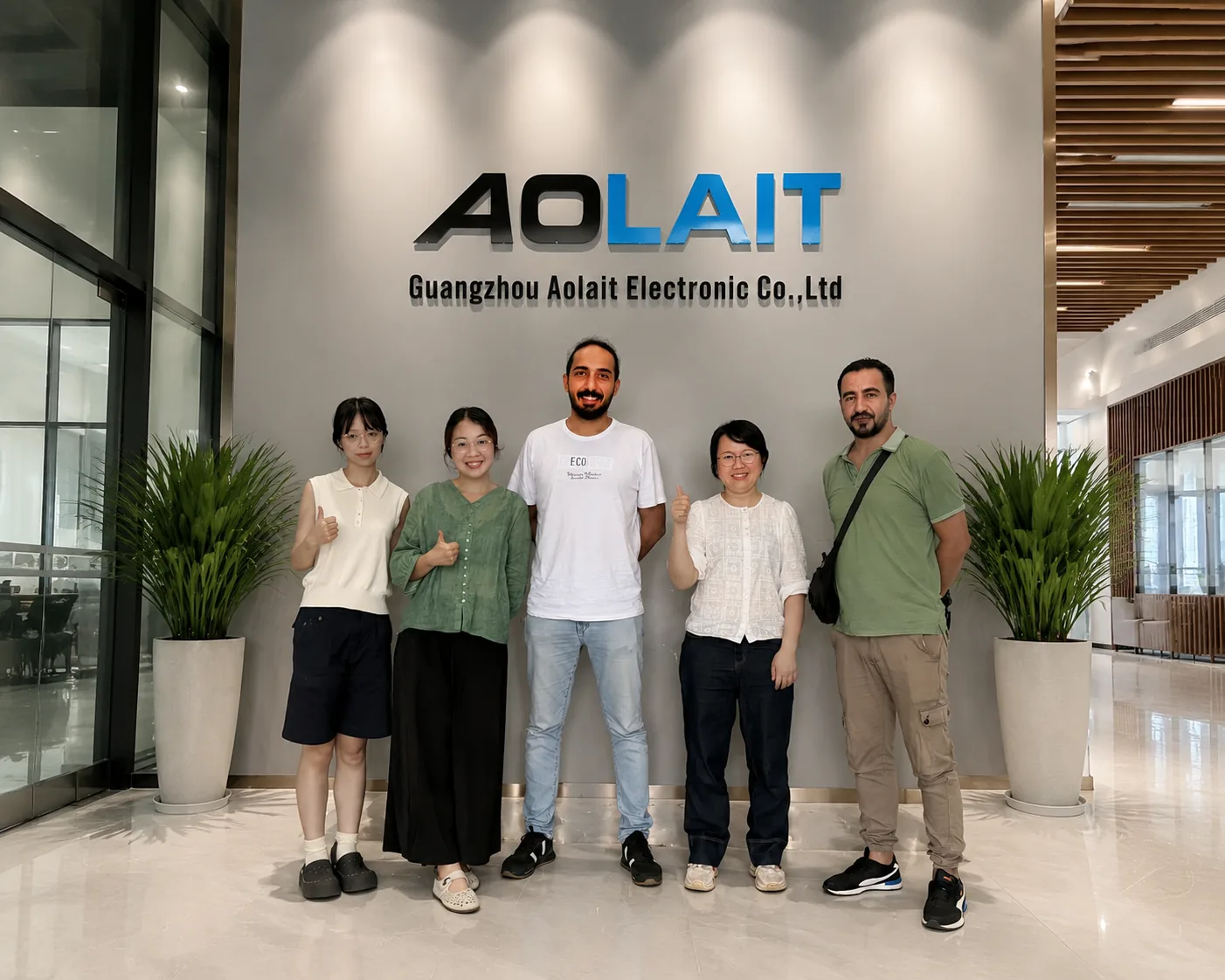 Aolait team members and visitors standing in the reception area of the Guangzhou manufacturing base