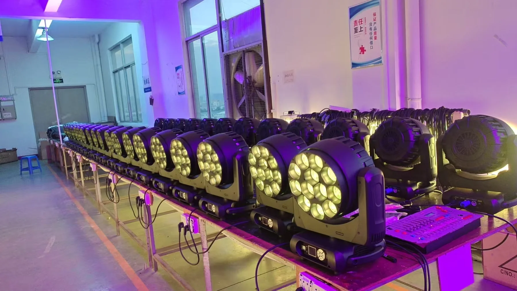 Rows of AOLAIT moving heads powered in a factory test area